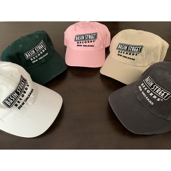 Five hats in five different colors—white, dark green, pink, stone, and grey, all embroidered with the Basin Street Records logo in black